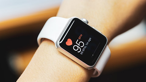 A close view of a person monitoring heart rate with a smart watch
