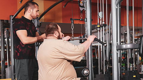A trainer with an obese client