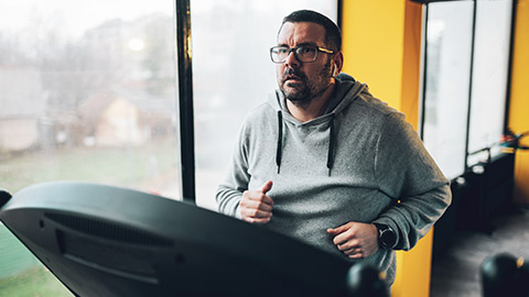 An obese male on a treadmill