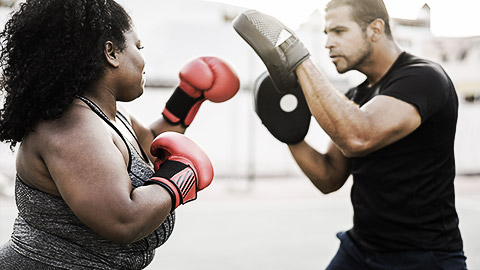 A person punching boxing mitts