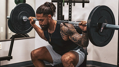 A person doing squats in a gym