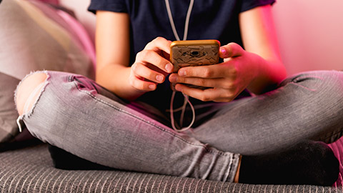 A close view of a young person using a phone