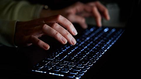 A person typing on a keyboard