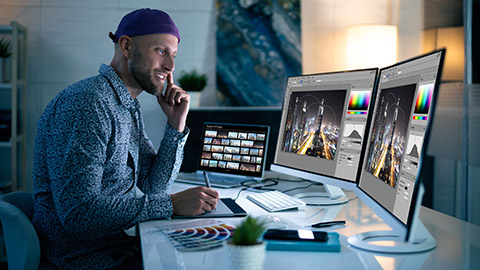 A photographer editing images on a computer