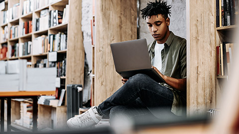 Student on e-learning inside a library