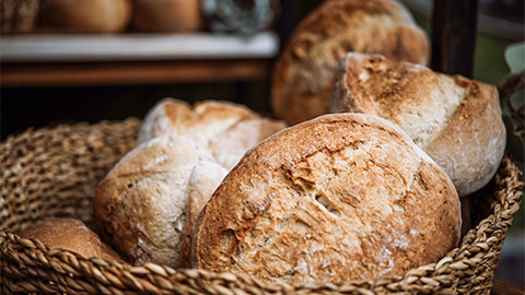 Artisanal bread on sale at a street pop-up market. Bakery and small local business concept