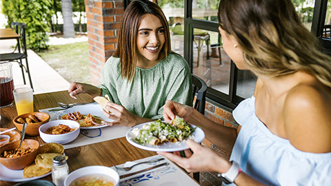 Group of latin friends eating mexican food in a restaurant terrace in Mexico Latin America