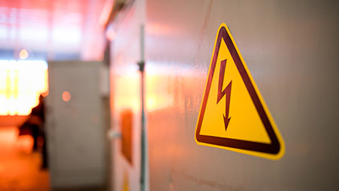 A close view of a high voltage sign