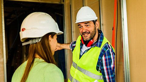 An electrician talking to a client