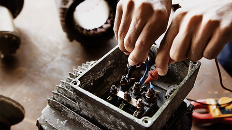 A person checking on an electric motor