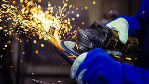 A person using an angle grinder