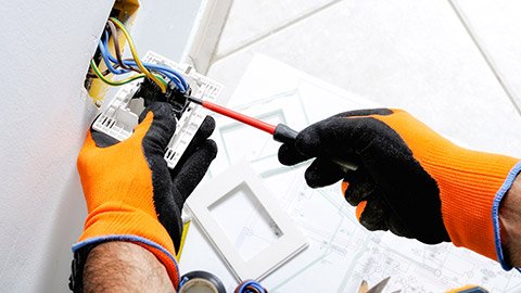 An electrician checking a power point