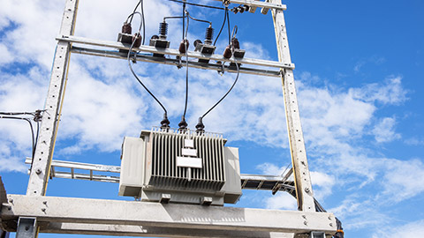 electrical post by the road with power line cables