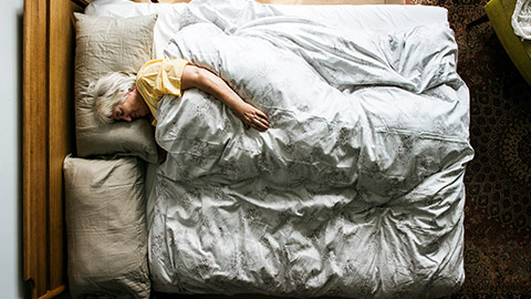 An elderly person sleeping