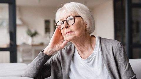 An elderly person with a worried look on their face