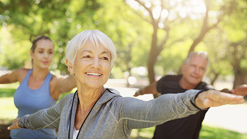 Cropped shot of a group of people practising yoga at the park