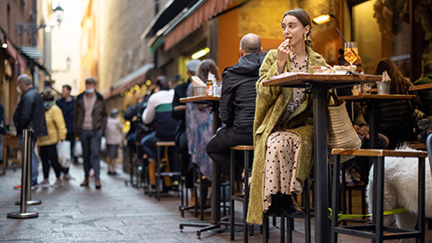 A person eating in an outdoor cafe