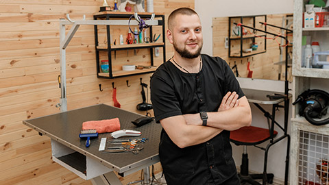 A pet groomer in his business