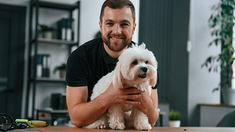 A person holding a dog