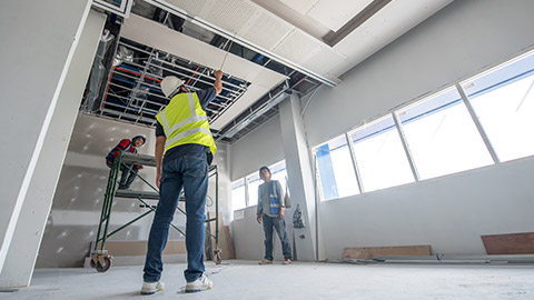 A foreman pointing at an area that needs to be fixed