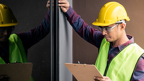 An inspector looking at windows