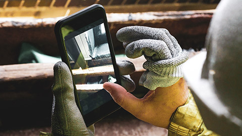 A person taking photos of incorrect work on a building site