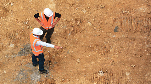 Top down view of 2 people ona construction site