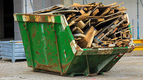 A full dumpster on a worksite