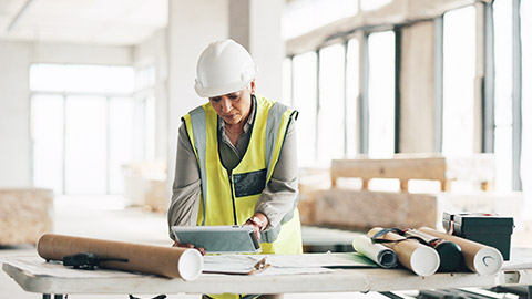 A person checking construction tasks on a tablet device