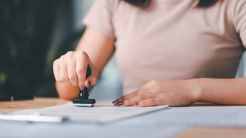 A person stamping a document