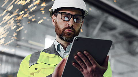 Man on construction using laptop