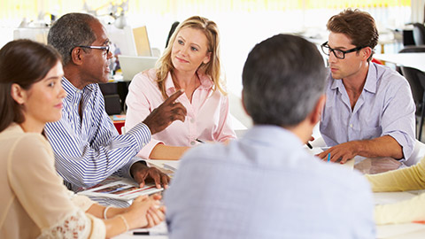 A group of colleagues talking in an office