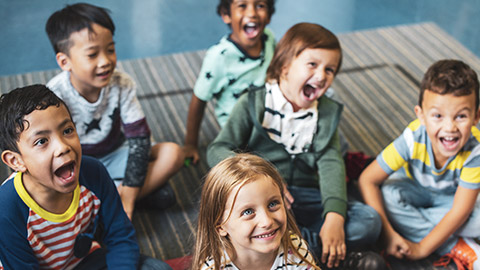 A diverse group of young kids in a classroom