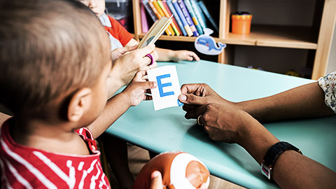 A child playing with alphabet blocks