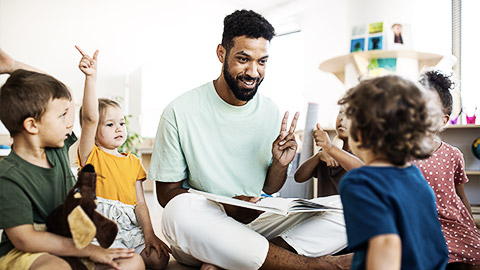 A person teaching a group of young children