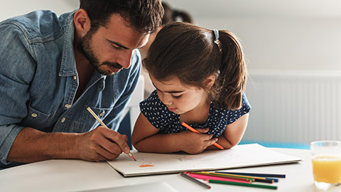 A father helping his daughter with a project