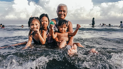 A grandmother with grandkids at the beach