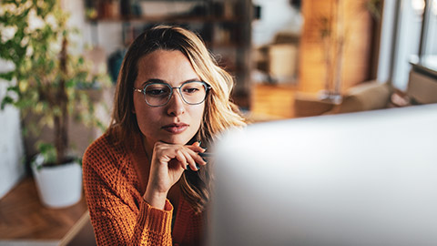 A person researching a job prospect on a computer