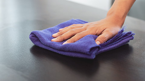 A person wiping off a surface