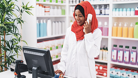 A pharmacist talking on the phone