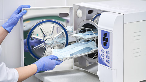 A pharmacist sterilising equipment