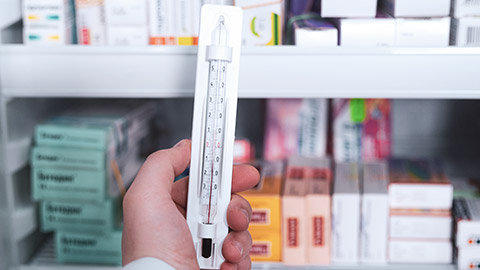 A person holding a thermometer