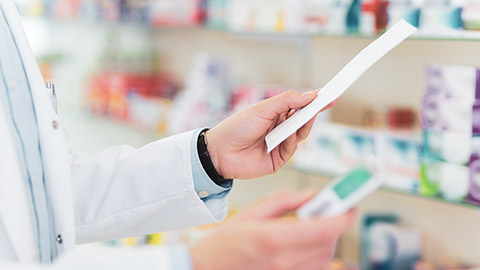 A pharmacist reading a doctor's script