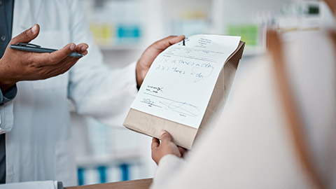 A pharmacist giving medication to a patient