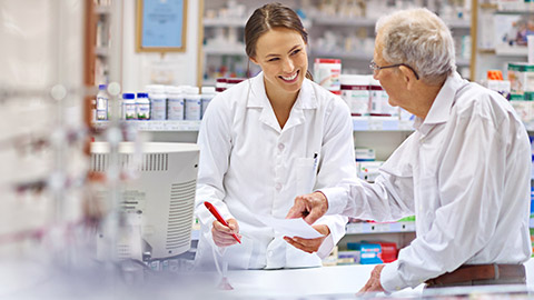 A pharmacist giving a prescription to a client