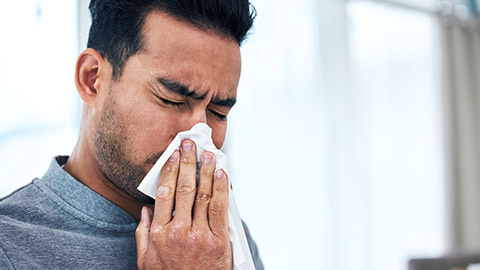 A person blowing their nose