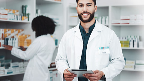 A pharmacist smiling at the camera