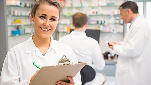 A pharmacist with a clipboard and a smile