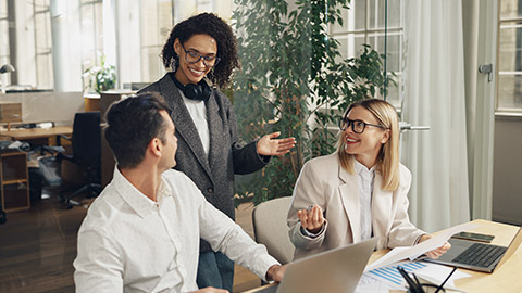 Group of business colleagues working together on project in modern coworking