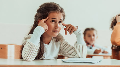 A young girl struggling with school